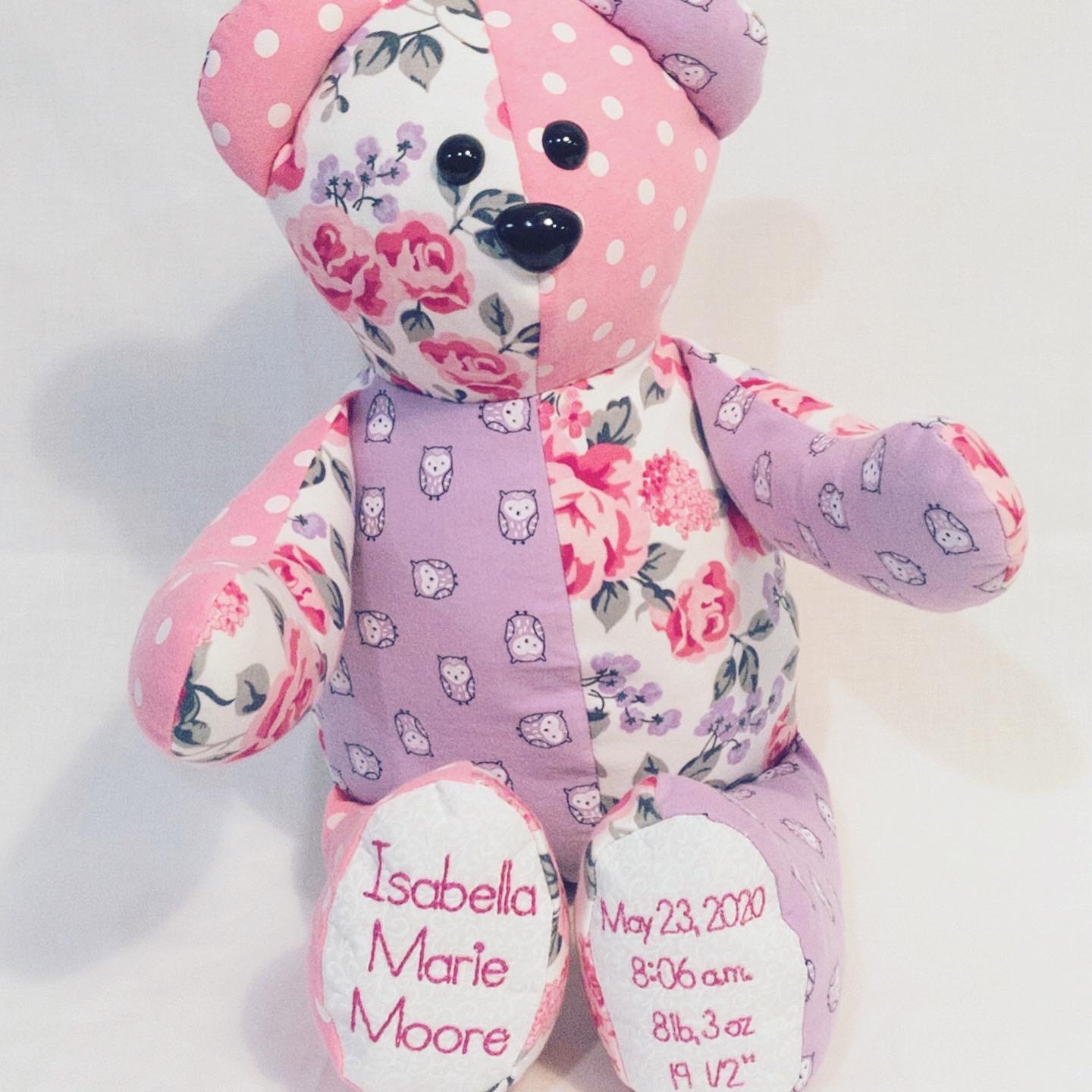 Pink and lavender floral memory bear for Isabella Marie Moore with birth stats on the feet