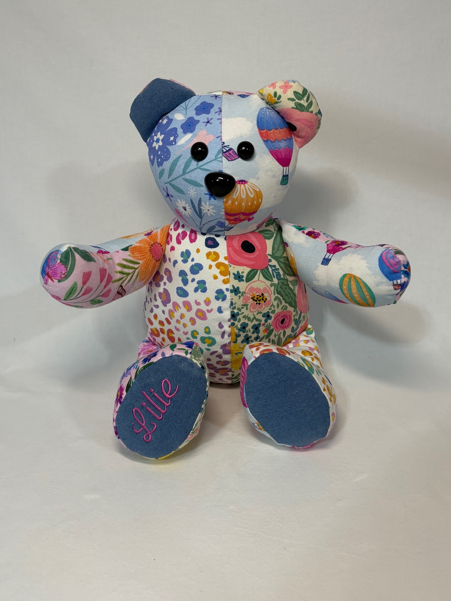 Colorful floral patchwork memory bear with 'Lilie' embroidered on a denim footpad
