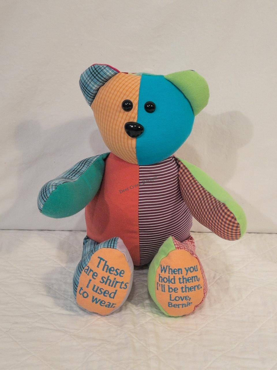 Colorful patchwork memory bear from Bernie's shirts with 'These are shirts I used to wear' embroidered on the feet