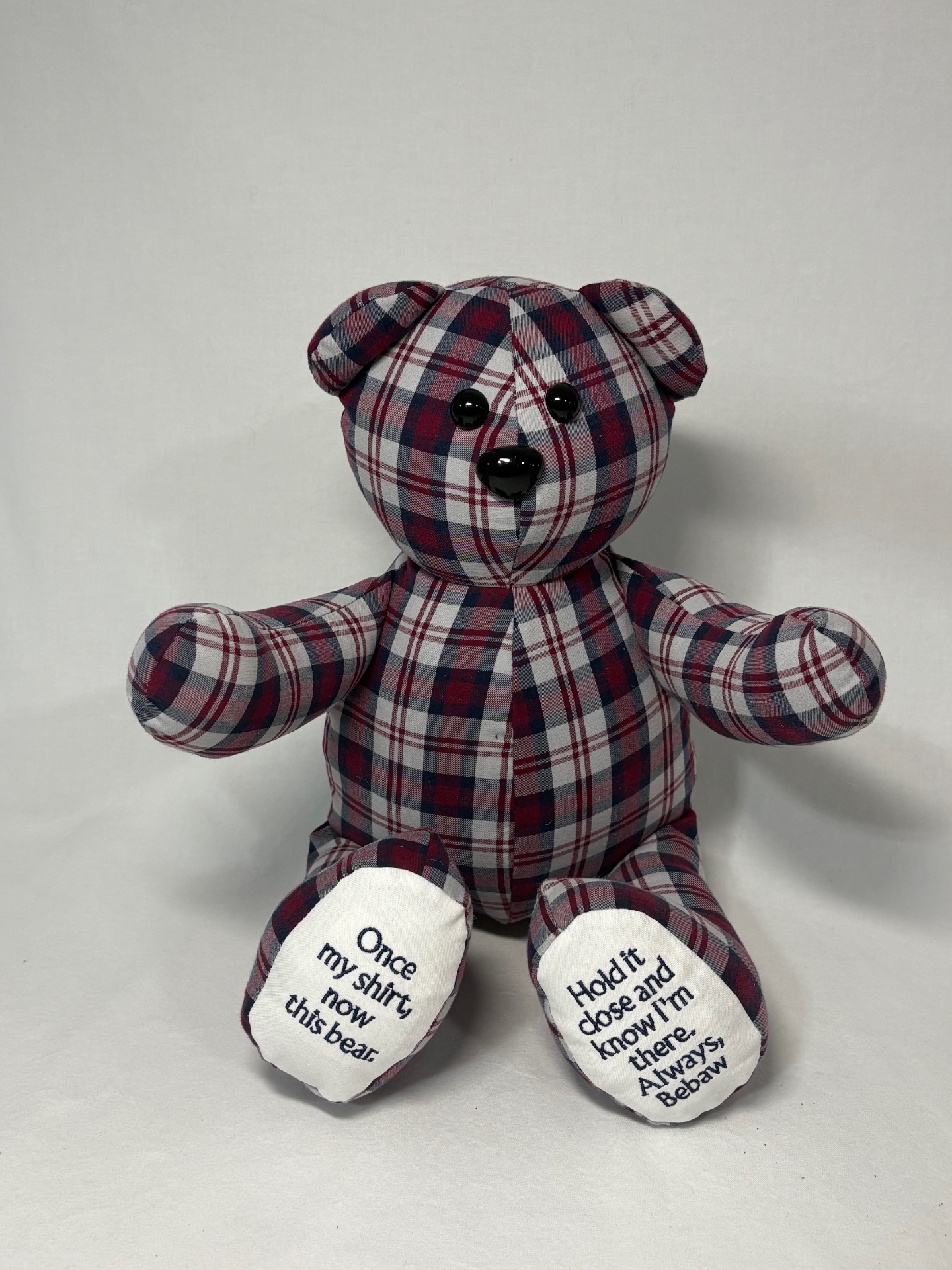 Burgundy and navy plaid memory bear with 'Once my shirt, now this bear' embroidered on the foot