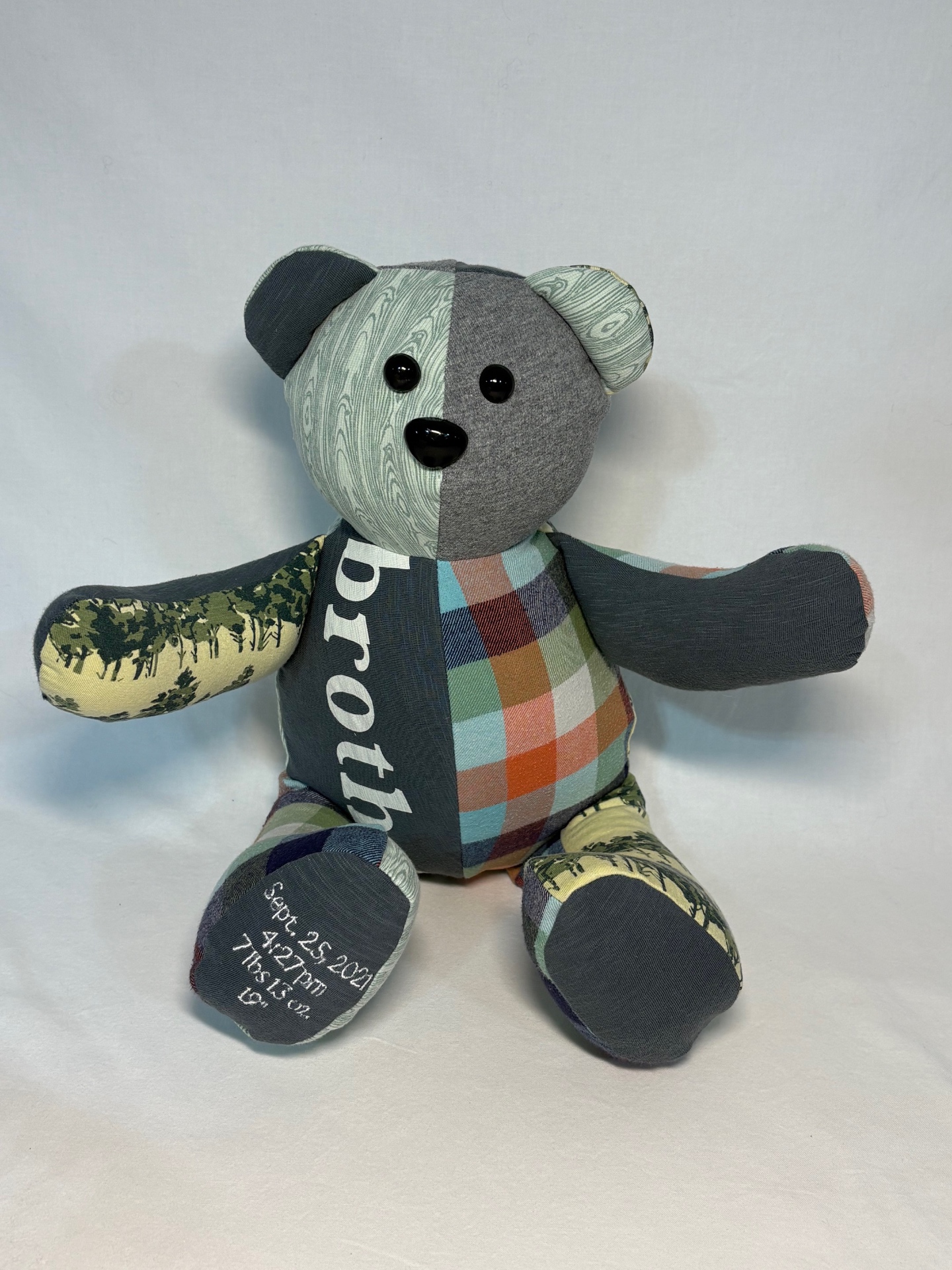 Plaid and woodland memory bear with 'brother' and birth details embroidered on the feet