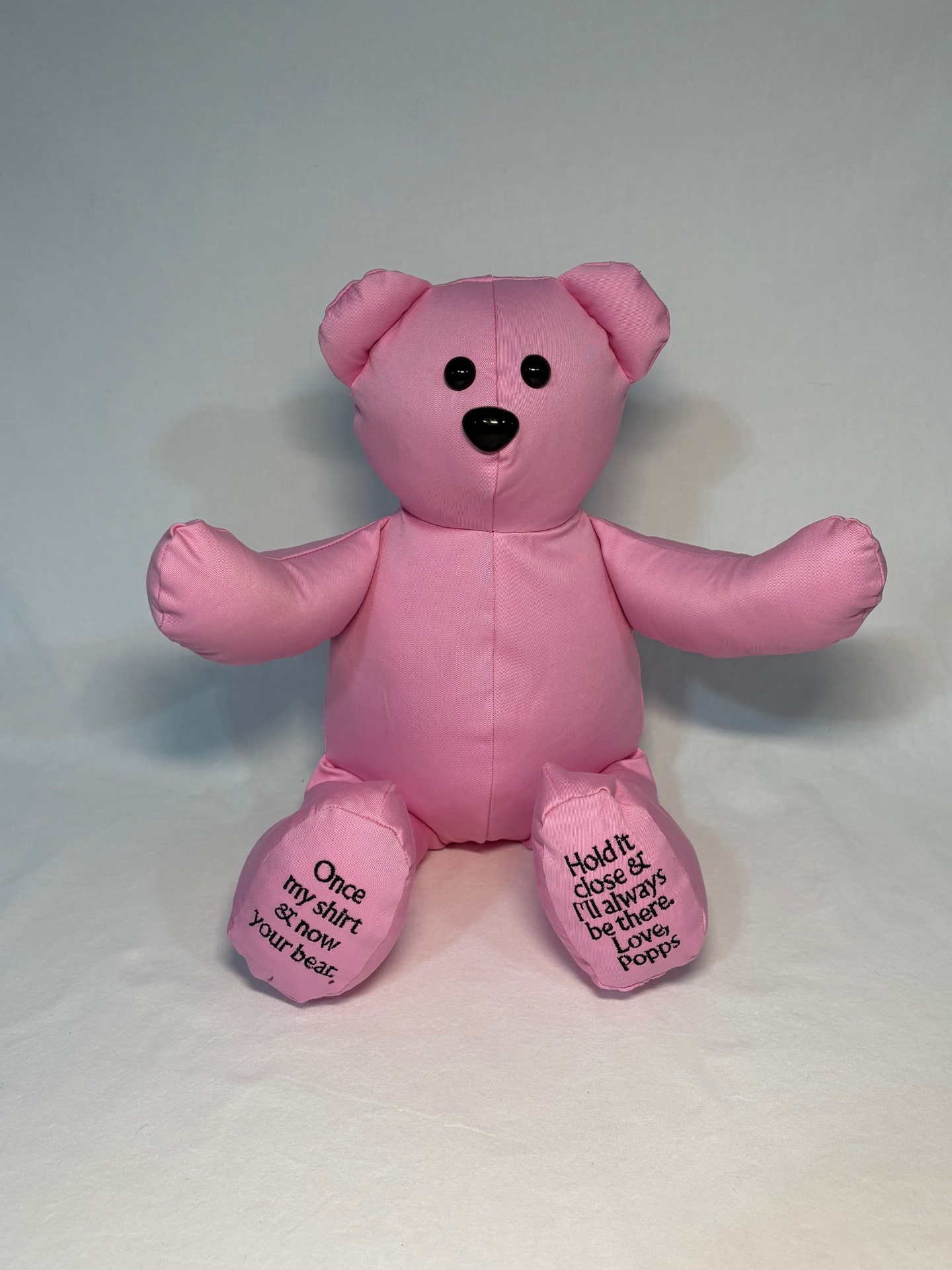Soft pink memory bear with 'Love, Popps' embroidered on the foot